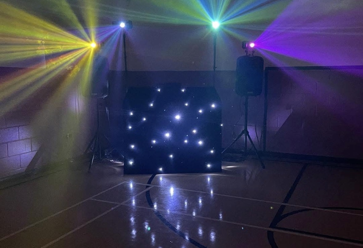 Colourful light beams over the DJ booth
